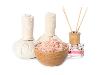 Photo of Spa composition. Herbal massage bags, sea salt and reed air freshener on white background