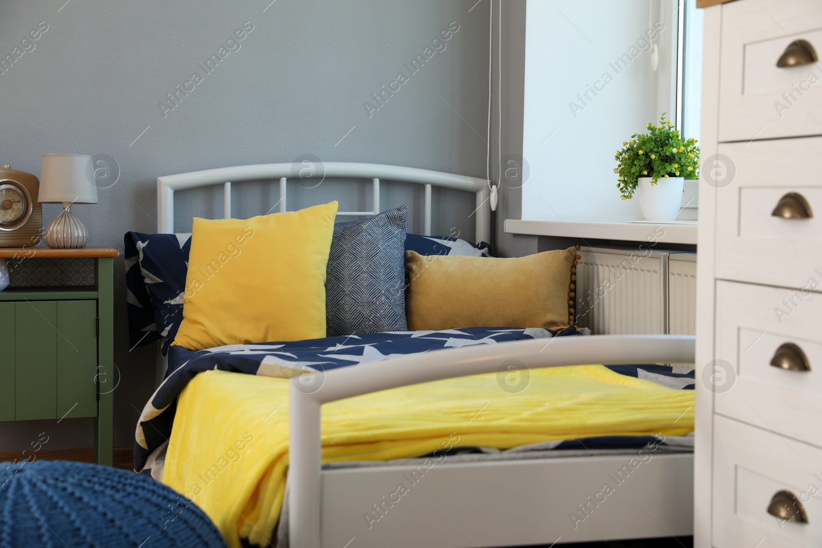 Photo of Stylish child room interior with comfortable bed near window