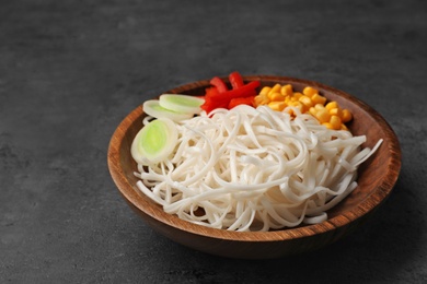 Photo of Plate with rice noodles and vegetables on table