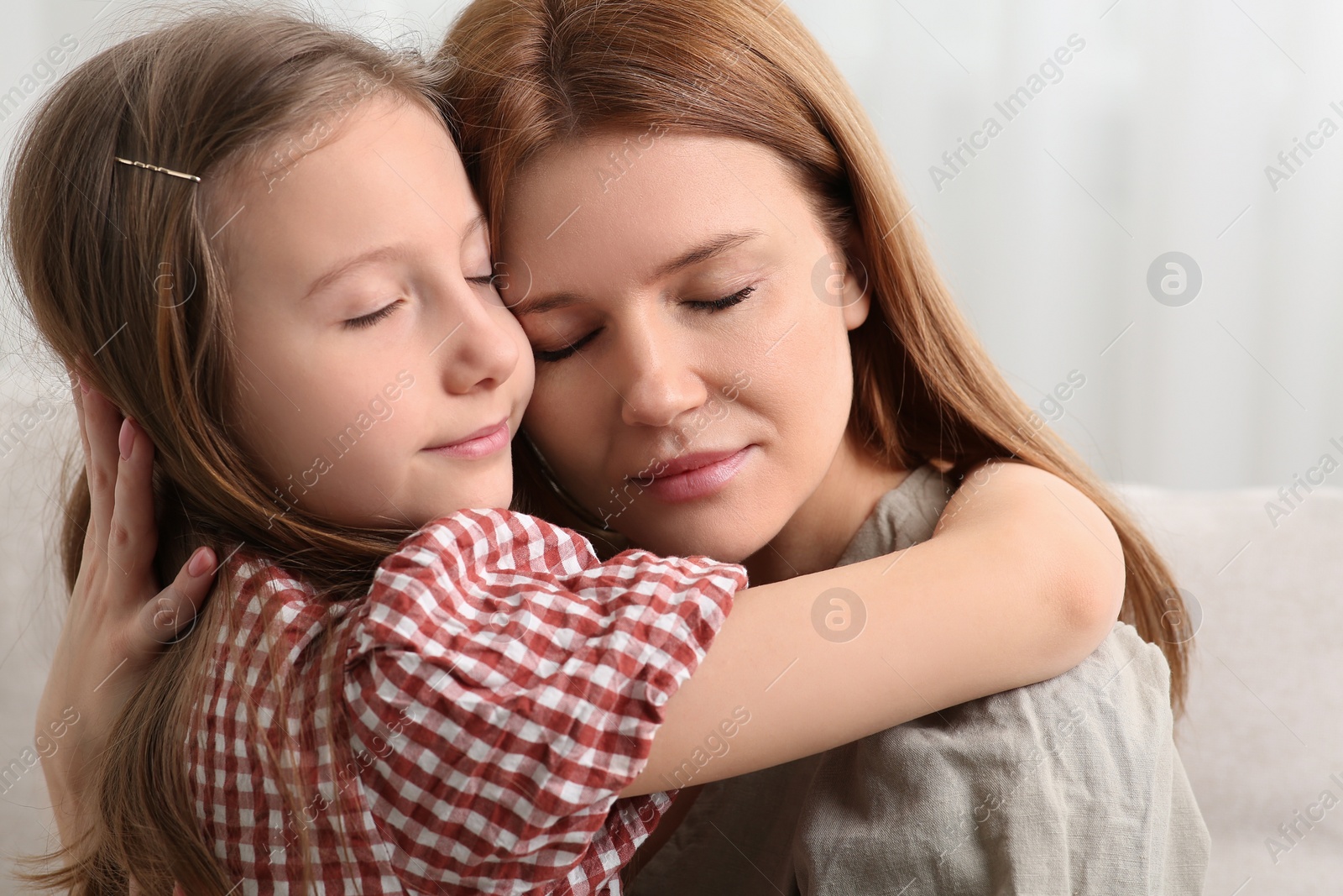 Photo of Portrait of mother and her cute daughter at home