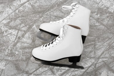Pair of figure skates on ice, above view