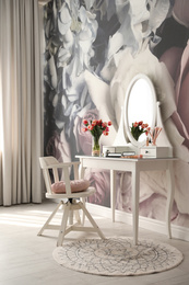 Photo of Stylish room interior with elegant dressing table and floral wallpaper