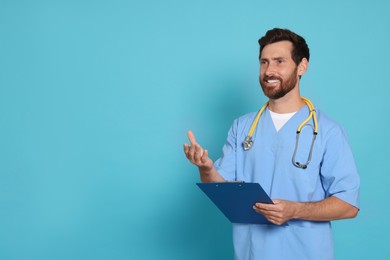 Happy doctor with stethoscope and clipboard on light blue background. Space for text
