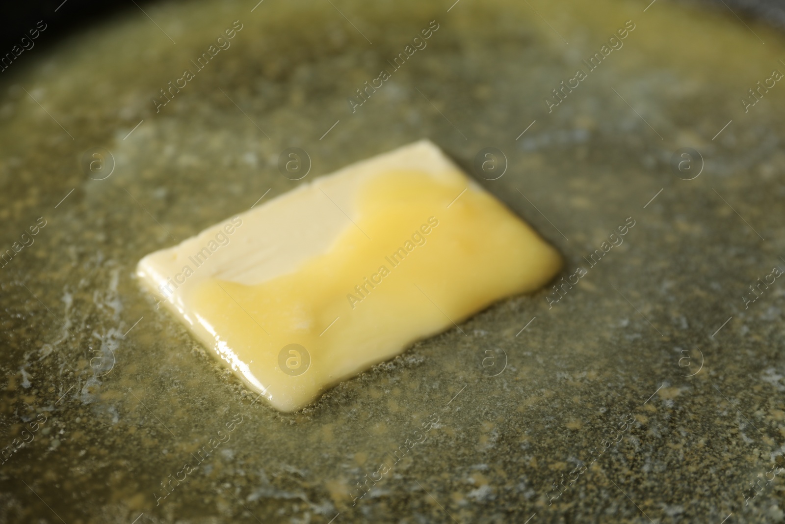 Photo of Tasty melting butter, closeup view. Dairy product