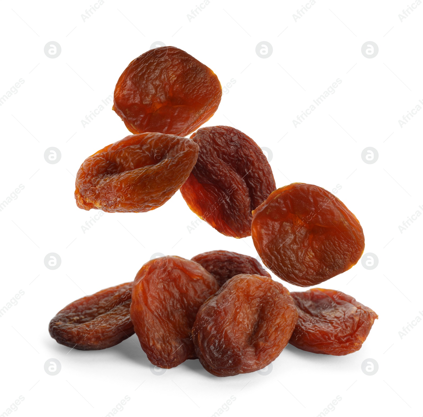 Image of Tasty dried apricots falling on white background