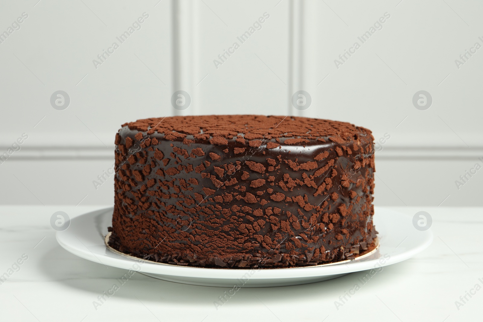 Photo of Delicious chocolate truffle cake on white marble table