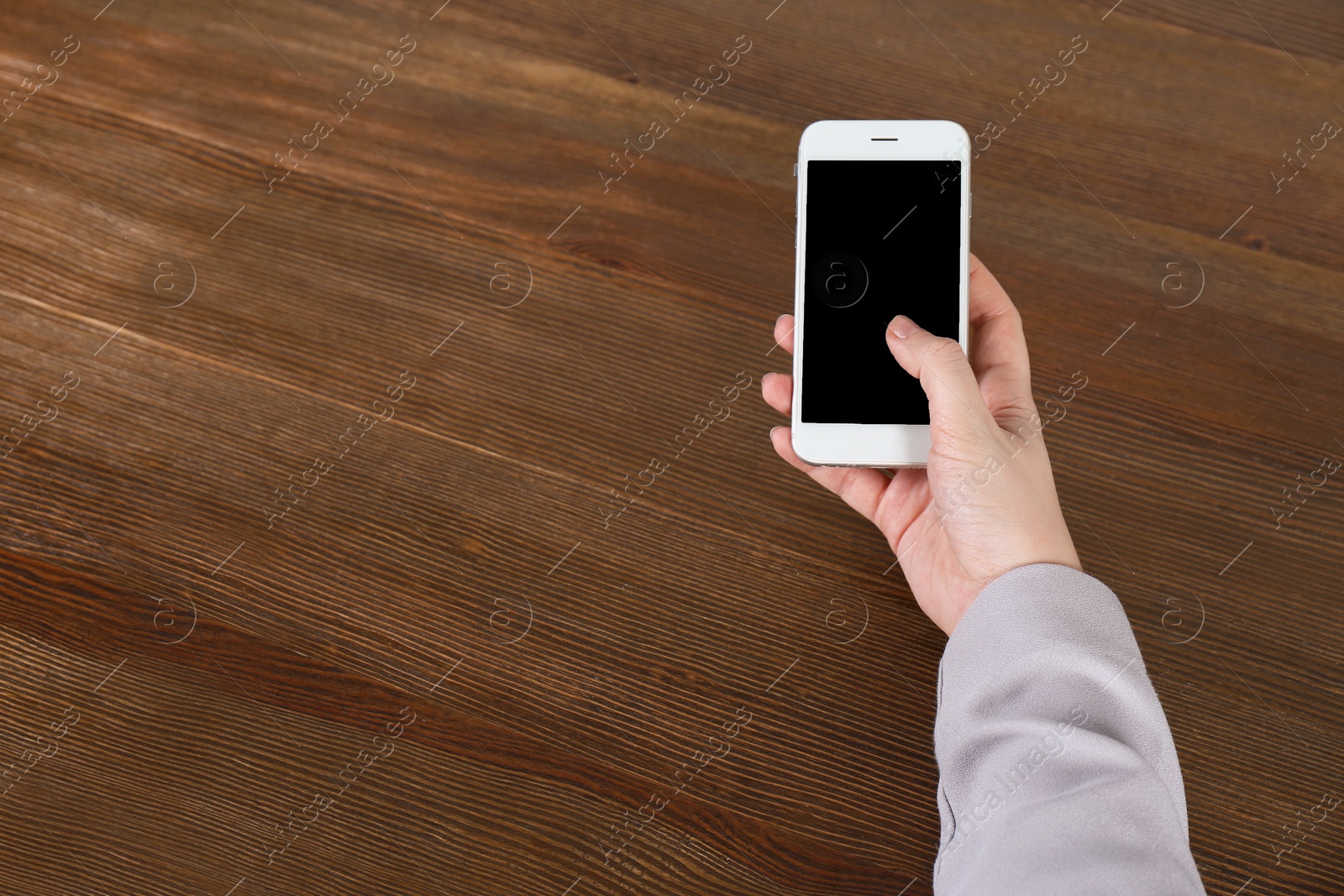 Photo of Woman using mobile phone at table, closeup with space for design