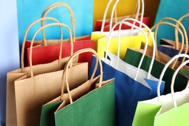 Colorful paper shopping bags as background, closeup