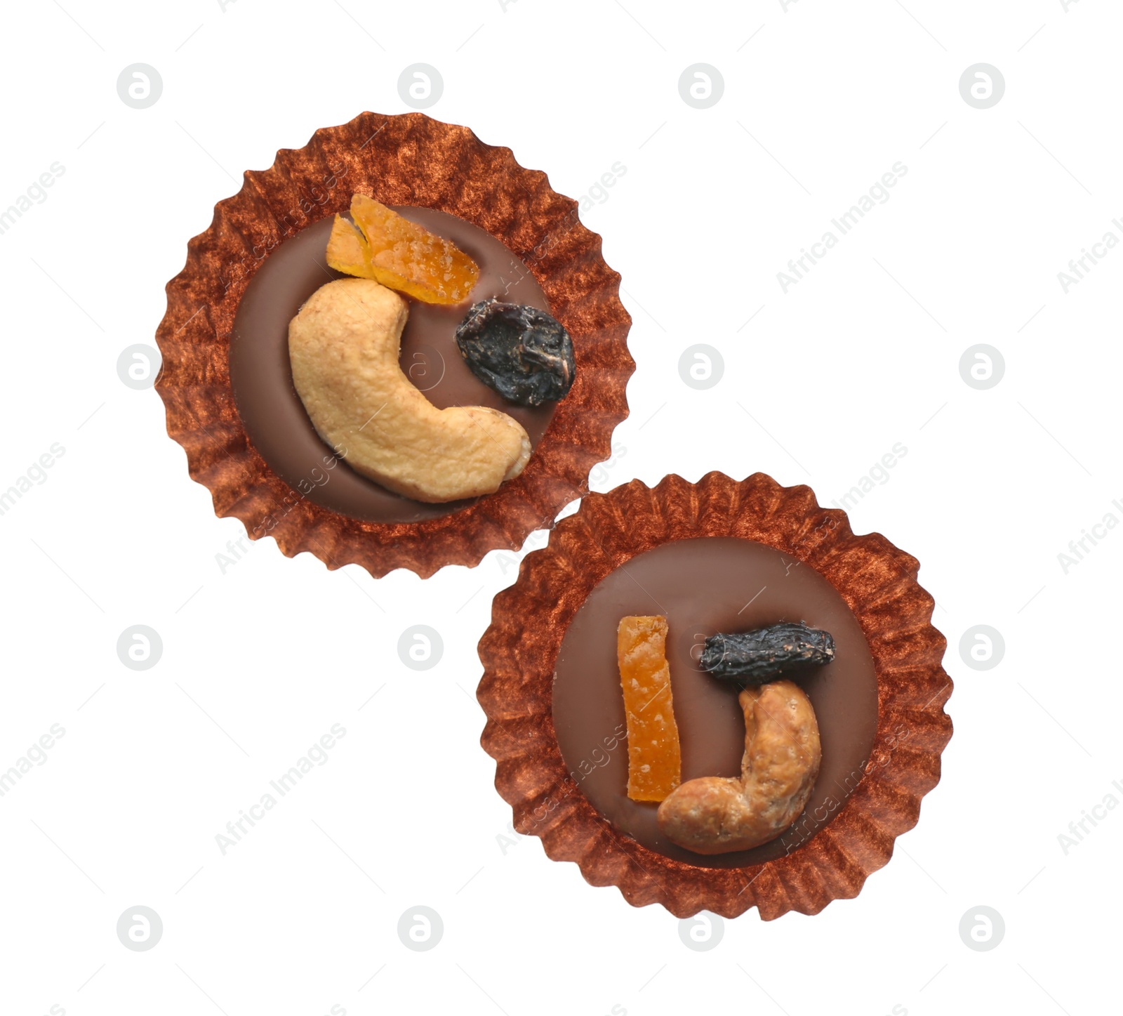 Photo of Delicious chocolate candies with cashew nuts and dried fruits on white background, top view