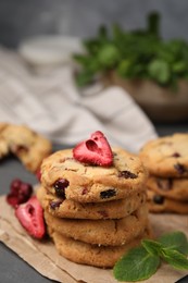 Photo of Cookies with freeze dried fruits and mint on grey table, closeup