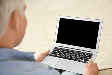 Man using video chat on laptop at home, closeup. Space for text