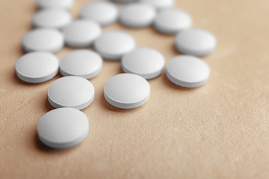 Photo of White pills on light background