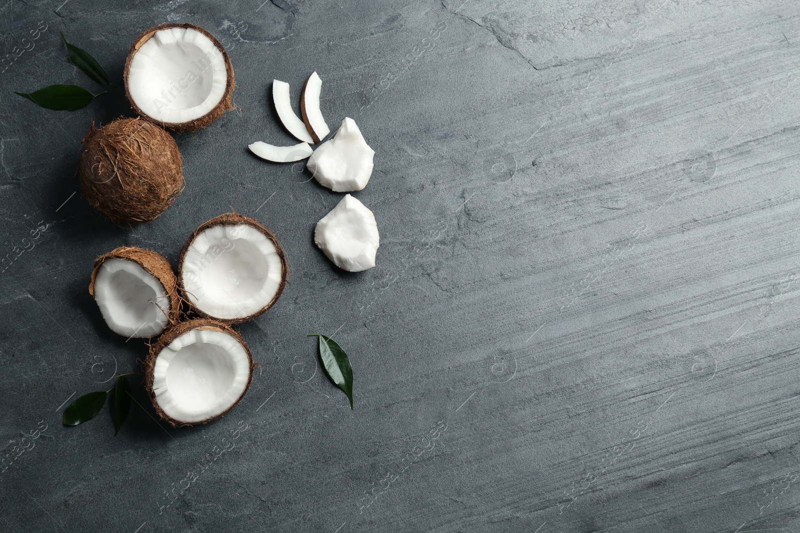 Photo of Flat lay composition with coconuts on grey table. Space for text