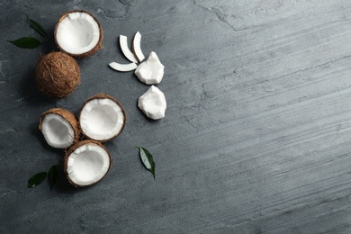 Photo of Flat lay composition with coconuts on grey table. Space for text