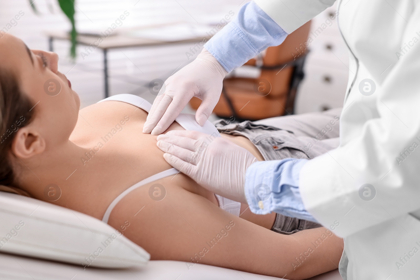 Photo of Mammologist checking young woman's breast in hospital