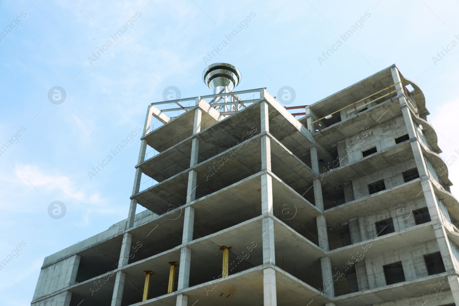 Photo of View of unfinished building outdoors. Construction safety rules