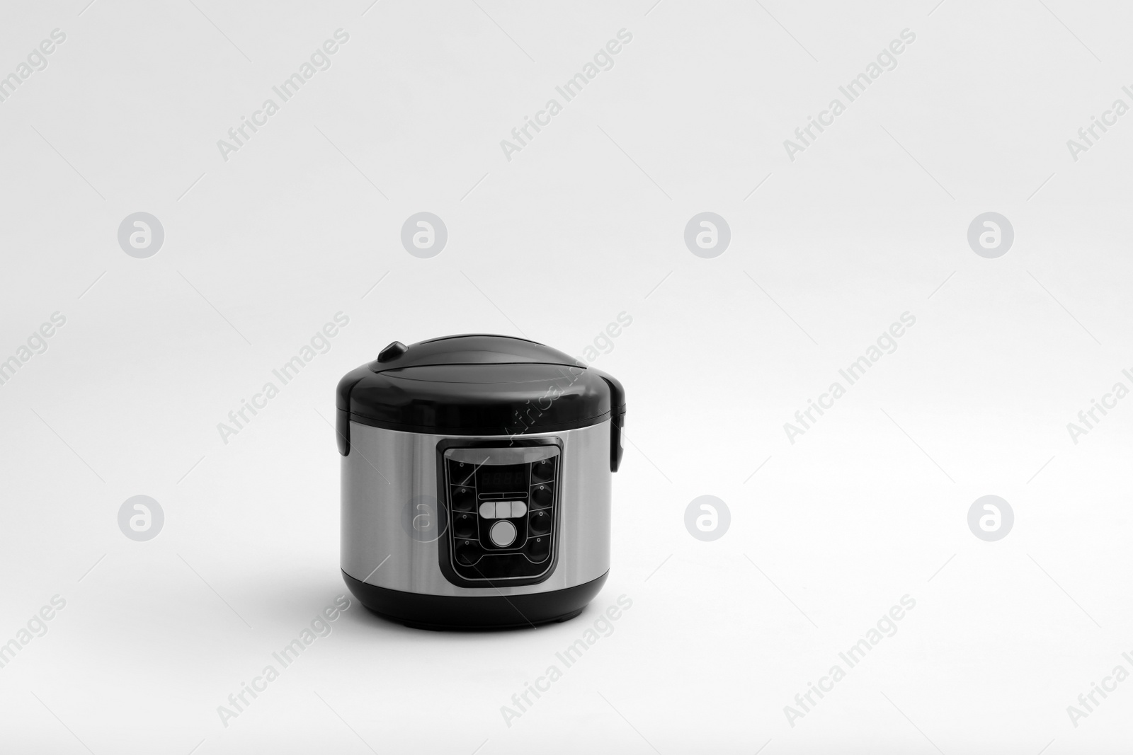 Photo of Modern electric multi cooker on light background. Space for text