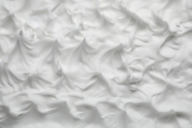 Texture of white shaving foam as background, top view