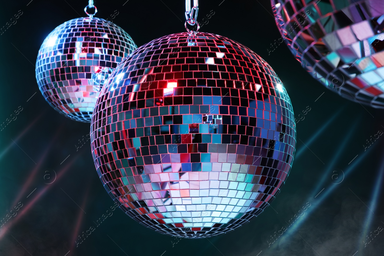 Photo of Bright shiny disco balls on dark background