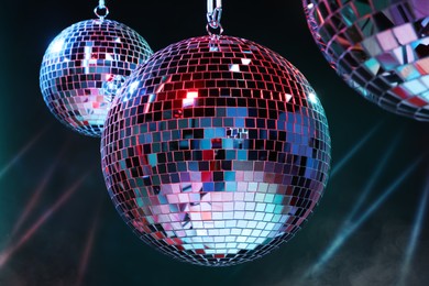 Photo of Bright shiny disco balls on dark background