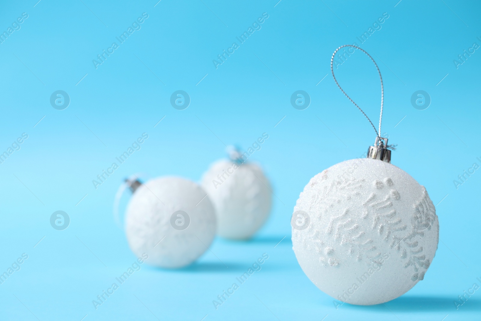 Photo of Beautiful Christmas balls on light blue background