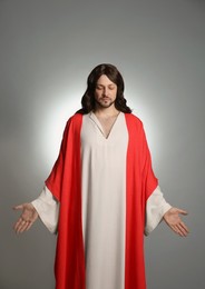 Photo of Jesus Christ with outstretched arms on light grey background