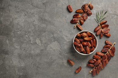 Photo of Tasty sweet dried dates on grey table, flat lay. Space for text