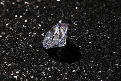 Beautiful dazzling diamond on dark shiny background