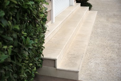 View of modern grey tile empty staircase near green plant outdoors