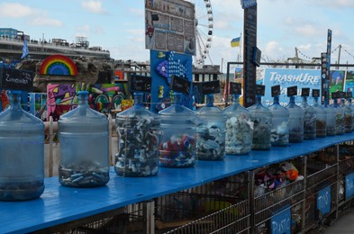 Photo of HAGUE, NETHERLANDS - SEPTEMBER 10, 2022: Many bottles as recycling containers outdoors on sunny day