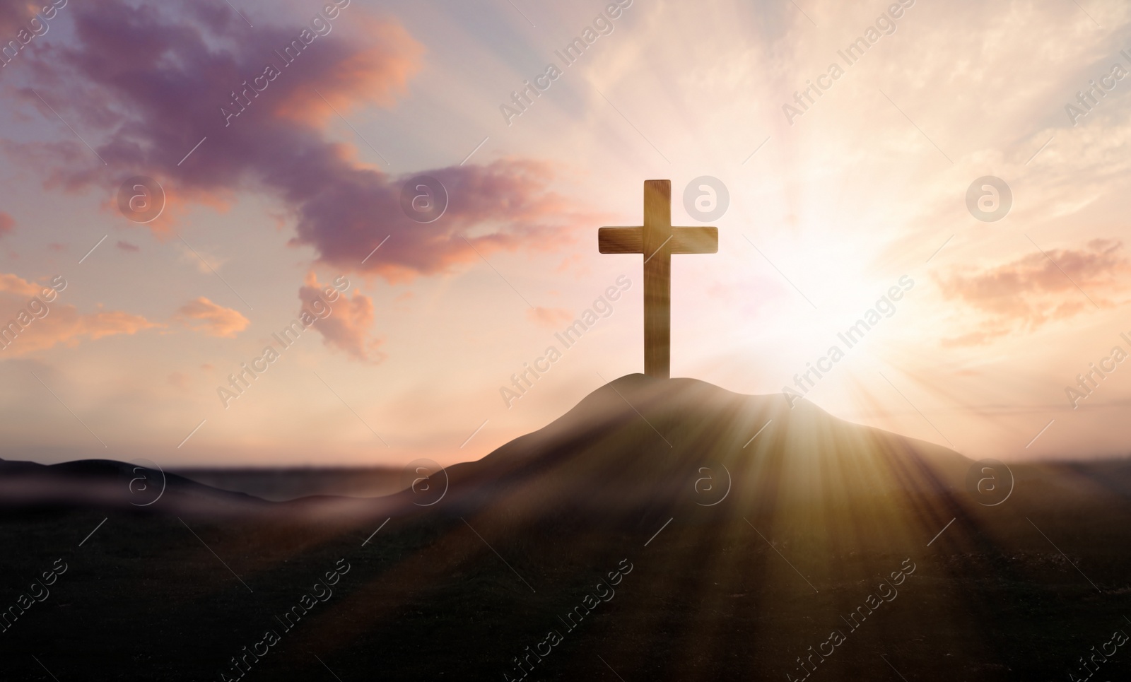 Image of Christian cross on hill outdoors at sunrise. Resurrection of Jesus