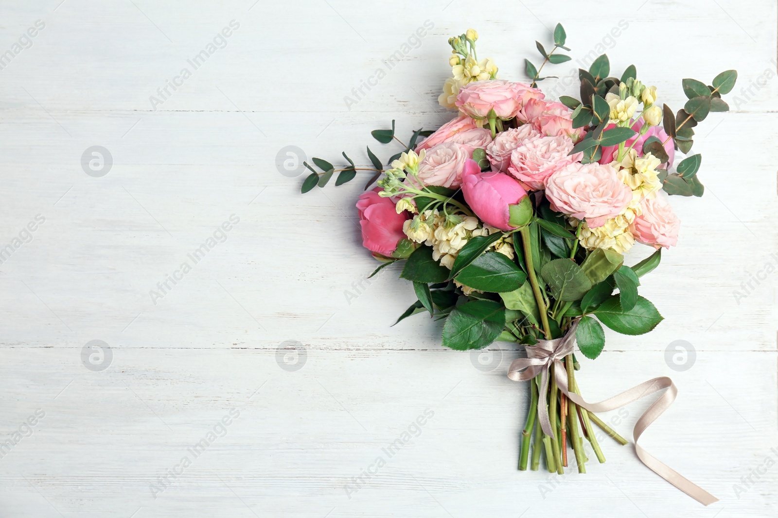 Photo of Bouquet of beautiful fragrant flowers on wooden background