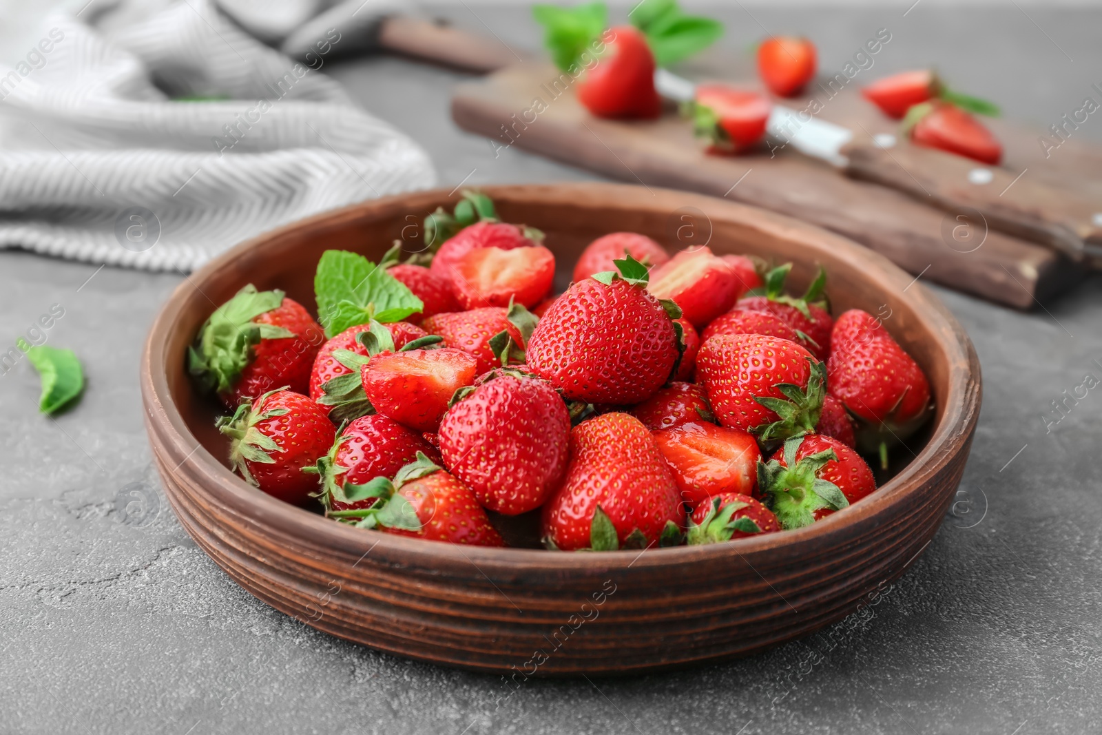 Photo of Plate with ripe red strawberries on table