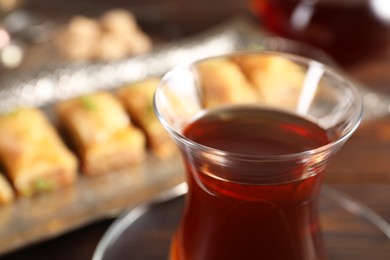 Photo of Traditional Turkish tea in glass on table, closeup. Space for text