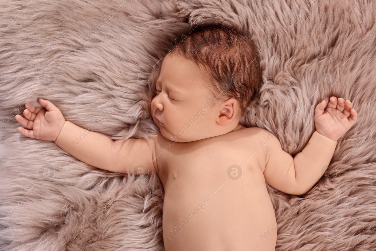 Photo of Cute newborn baby sleeping on fluffy blanket, top view