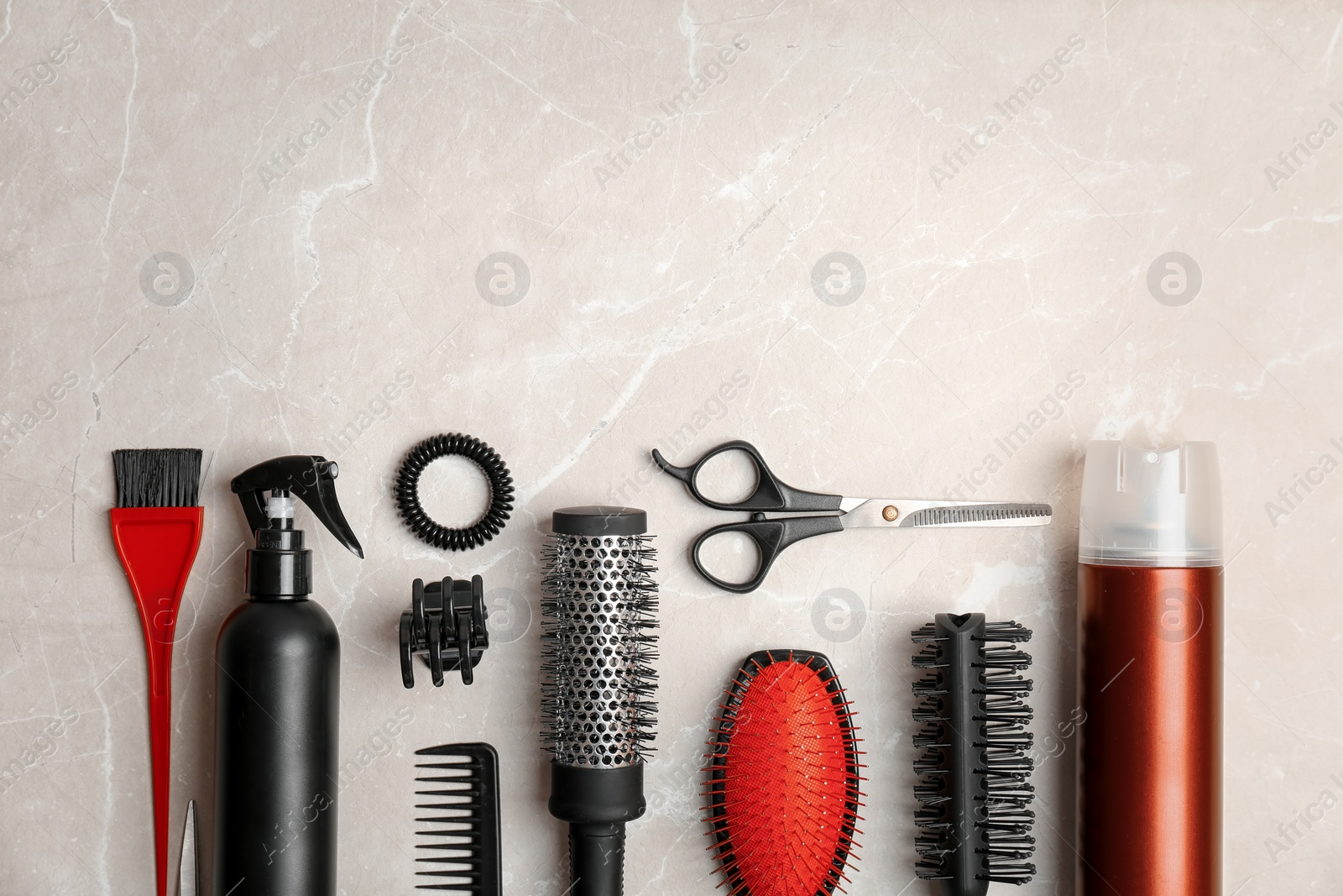 Photo of Flat lay composition with professional hairdresser tools on grey background