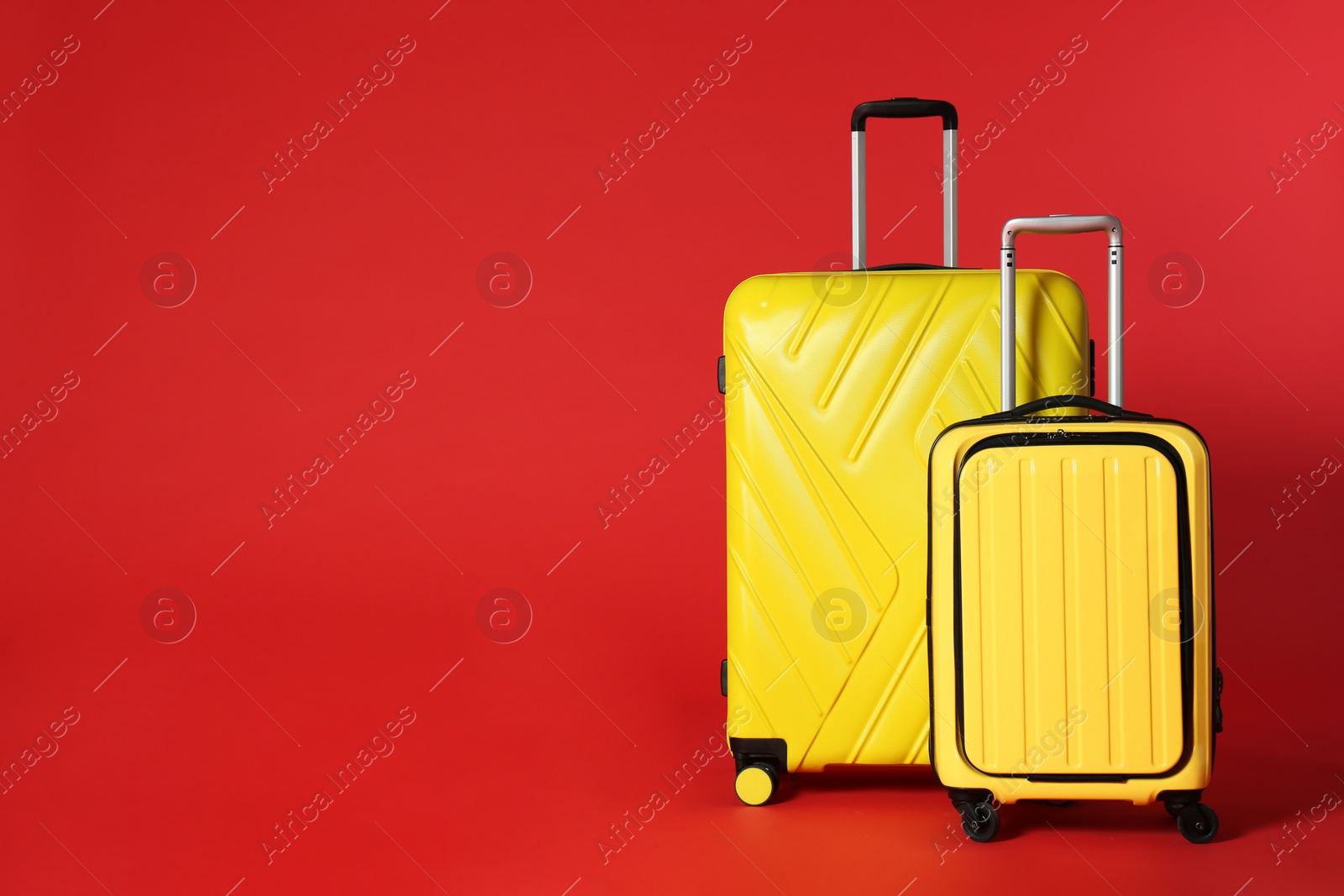 Photo of Stylish suitcases on color background. Space for text