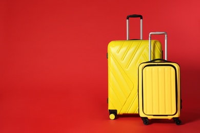 Photo of Stylish suitcases on color background. Space for text