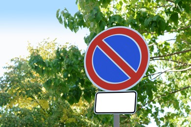 Photo of No parking road sign on city street, space for text. Traffic rules