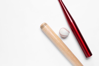 Photo of Baseball bats and ball on white background, flat lay. Space for text