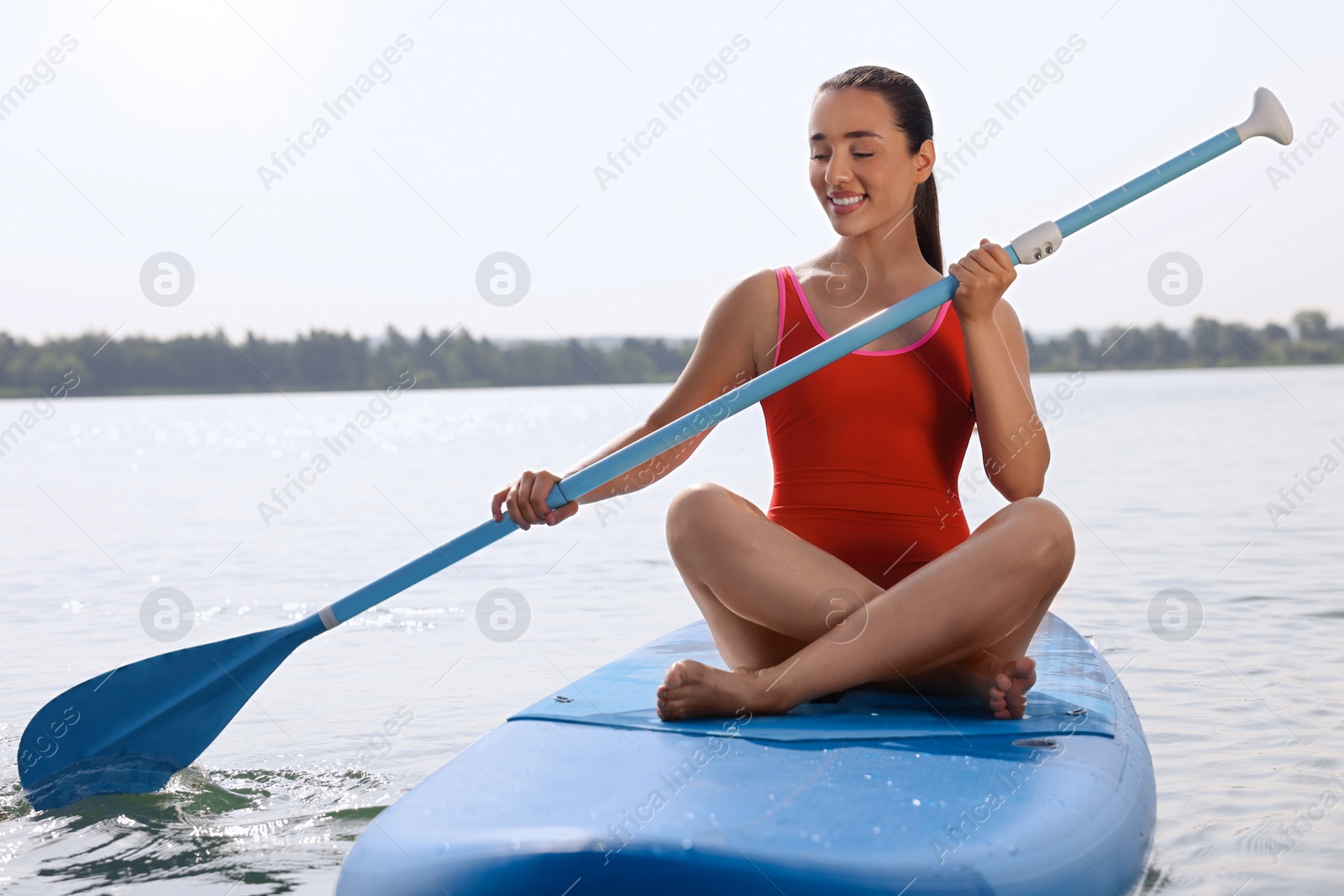 Photo of Woman paddle boarding on SUP board in sea