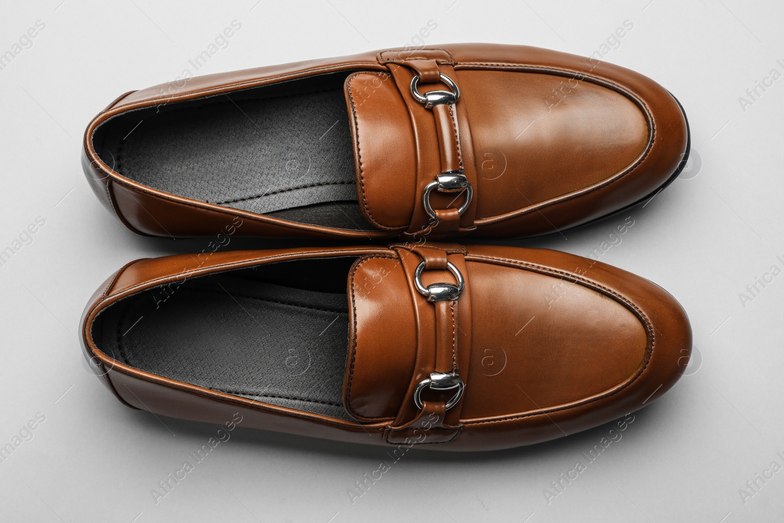 Photo of Pair of stylish male shoes on grey background, flat lay