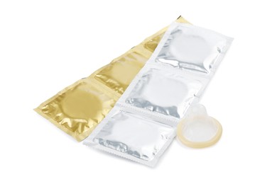 Unpacked condom and packages on white background. Safe sex