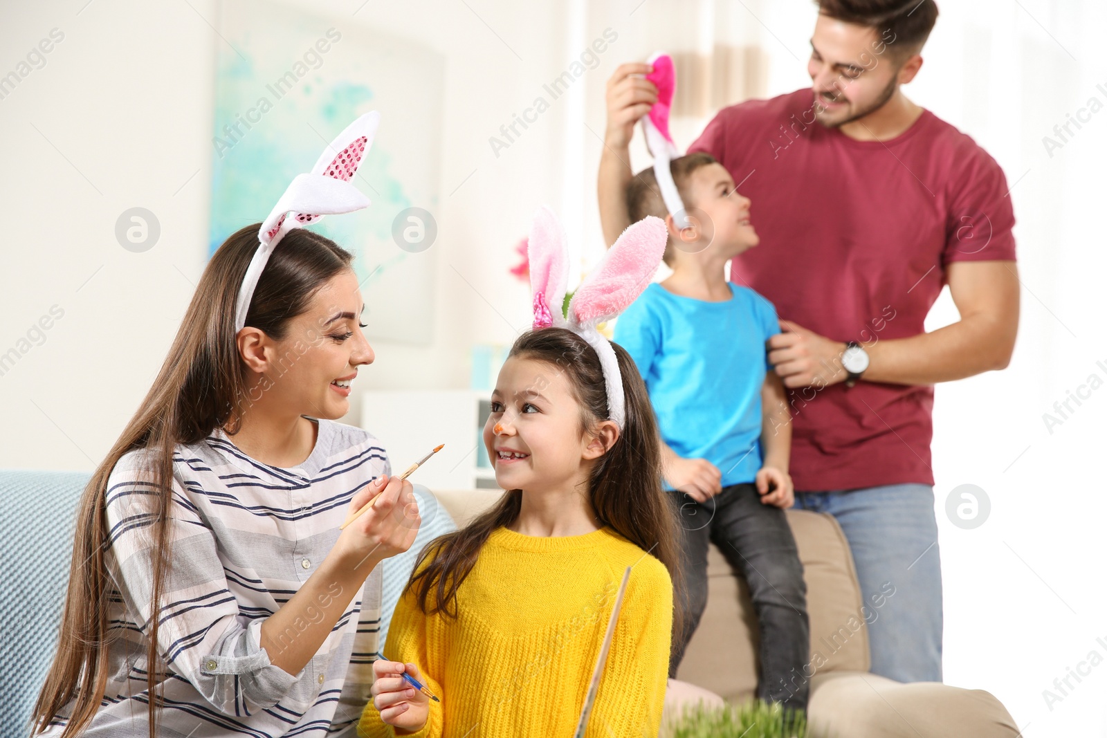 Photo of Happy family preparing for Easter holiday at home