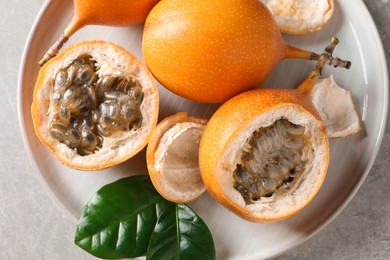 Photo of Delicious ripe granadillas on light table, top view