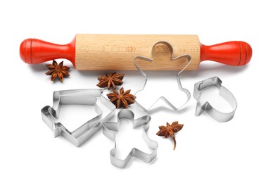 Photo of Cookie cutters, rolling pin and anise stars on white background