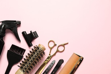 Photo of Professional hair dresser tools on pink background, flat lay. Space for text