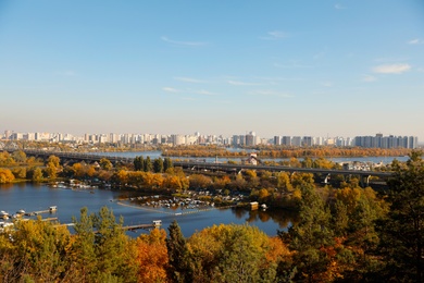 Photo of Picturesque view of river and trees with bright leaves. Autumn season