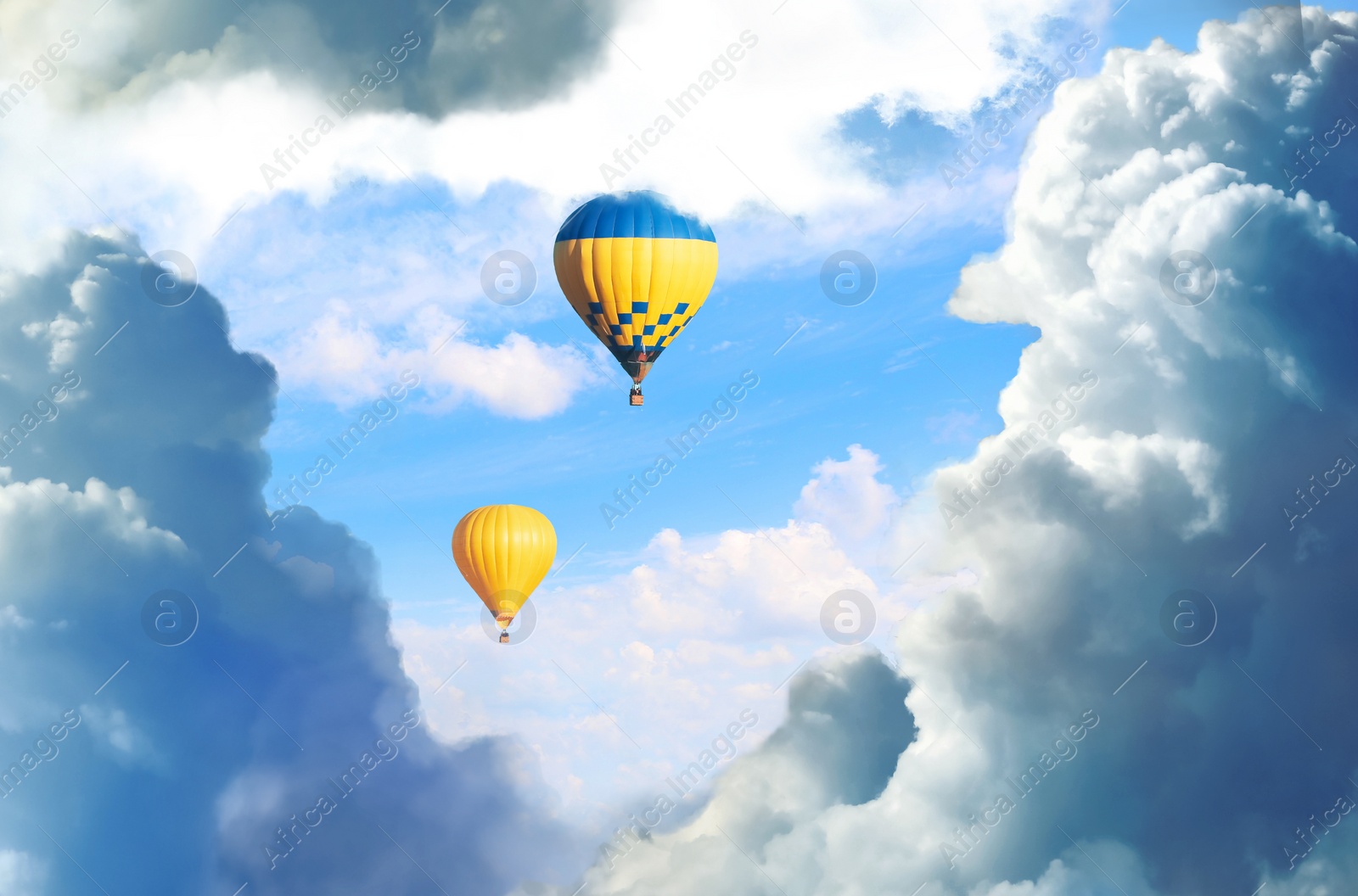 Image of Fantastic dreams. Hot air balloons in blue sky with fluffy clouds 