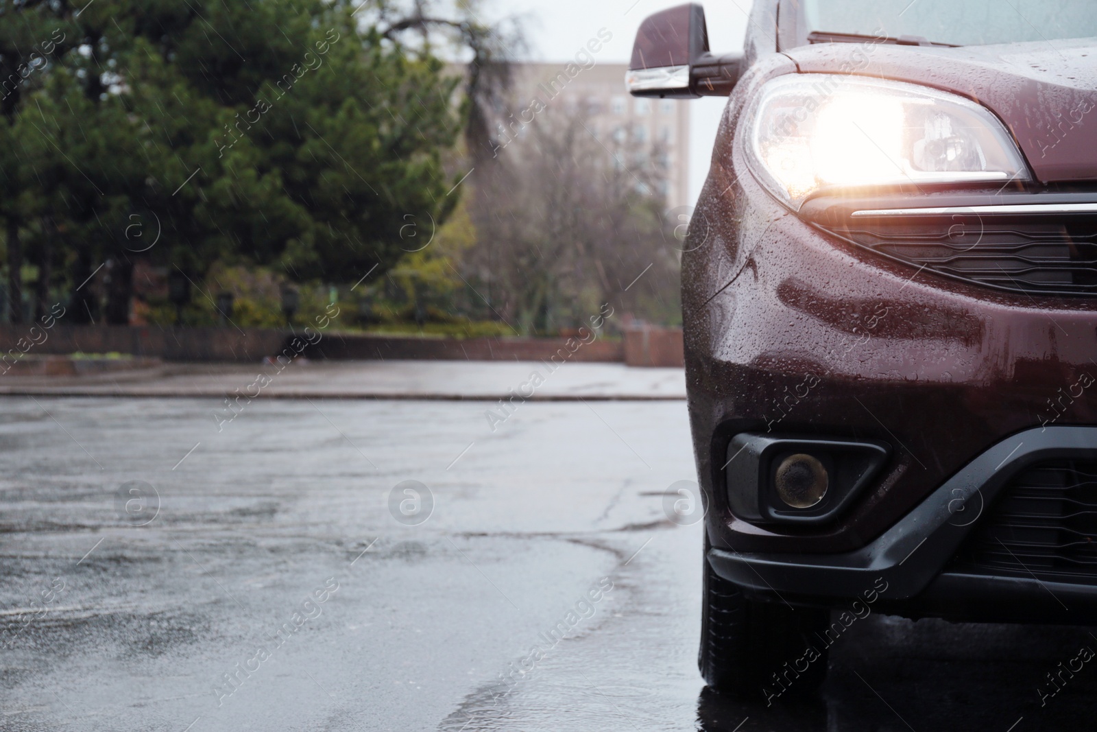 Photo of Car parked outdoors on rainy day, closeup